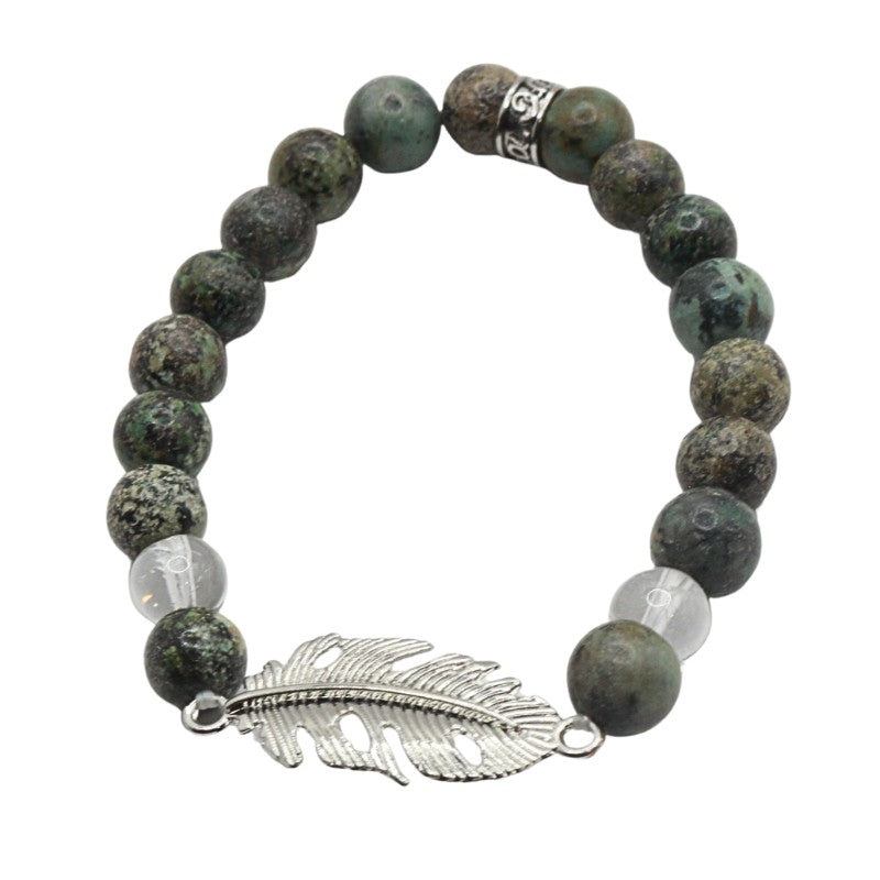 Bracelet with green beads and a silver feather charm on a white background