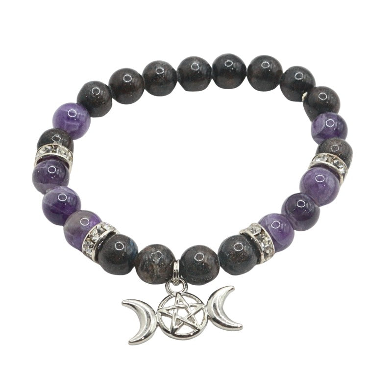 Beaded bracelet with purple and black stones and a silver pentacle charm on a white background