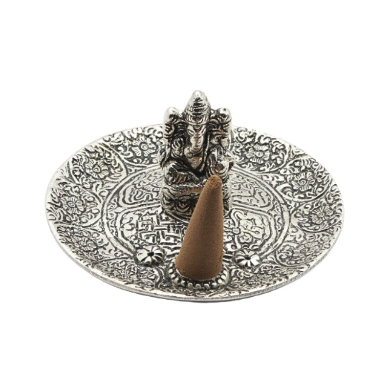incense cone on an aluminium incense burner with ganesh in the centre