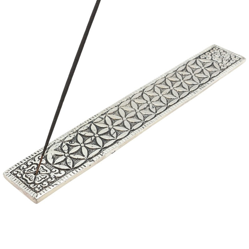 incense stick in an aluminium incense burner with flower of life pattern