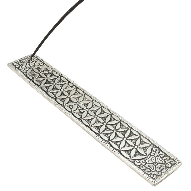 incense stick in an aluminium incense burner with flower of life pattern