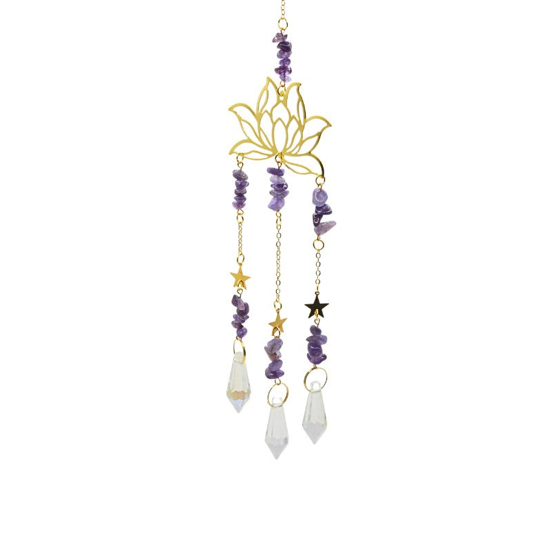 Decorative hanging ornament with lotus flower design, beads, and crystals on a white background