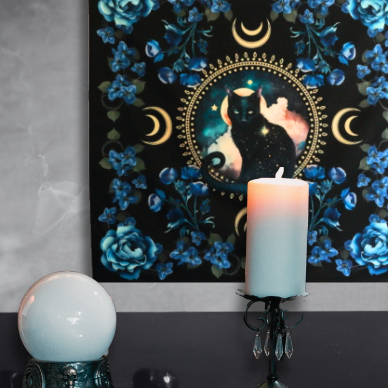 Black Cat Familiar Wall Hanging behind a crystal ball and candle