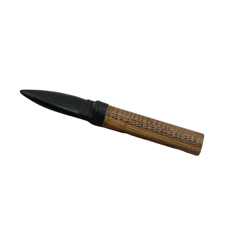 Decorative knife with wooden handle and black blade on a white background