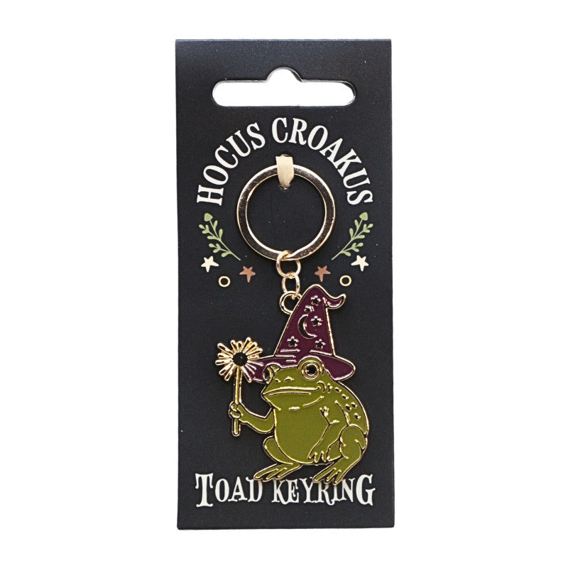 keyring with a gold chain shaped as a toad on a black background