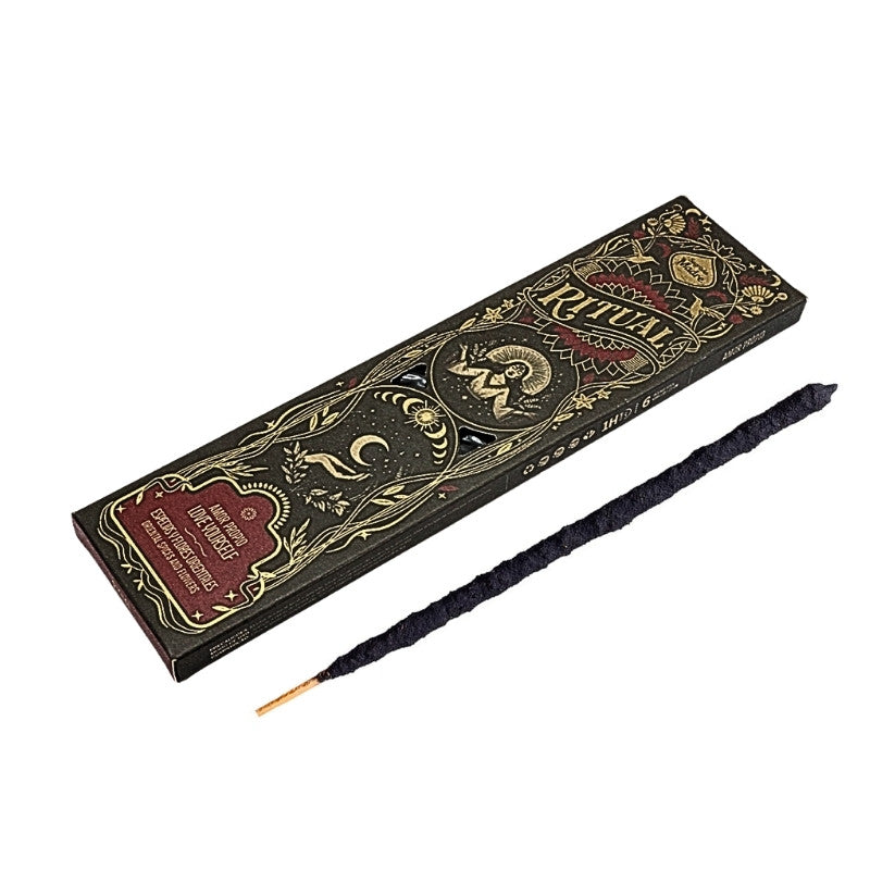 incense stick next to a decorative box of incense by Sagrada Madre