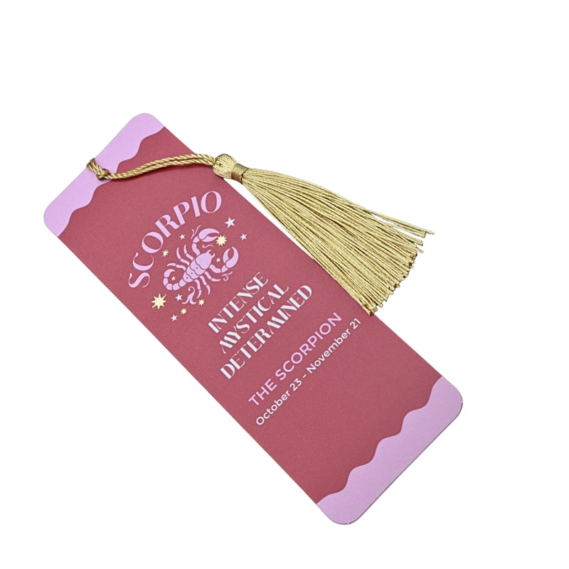 pink and red bookmark with gold tassel and white and pink writing, on a white background