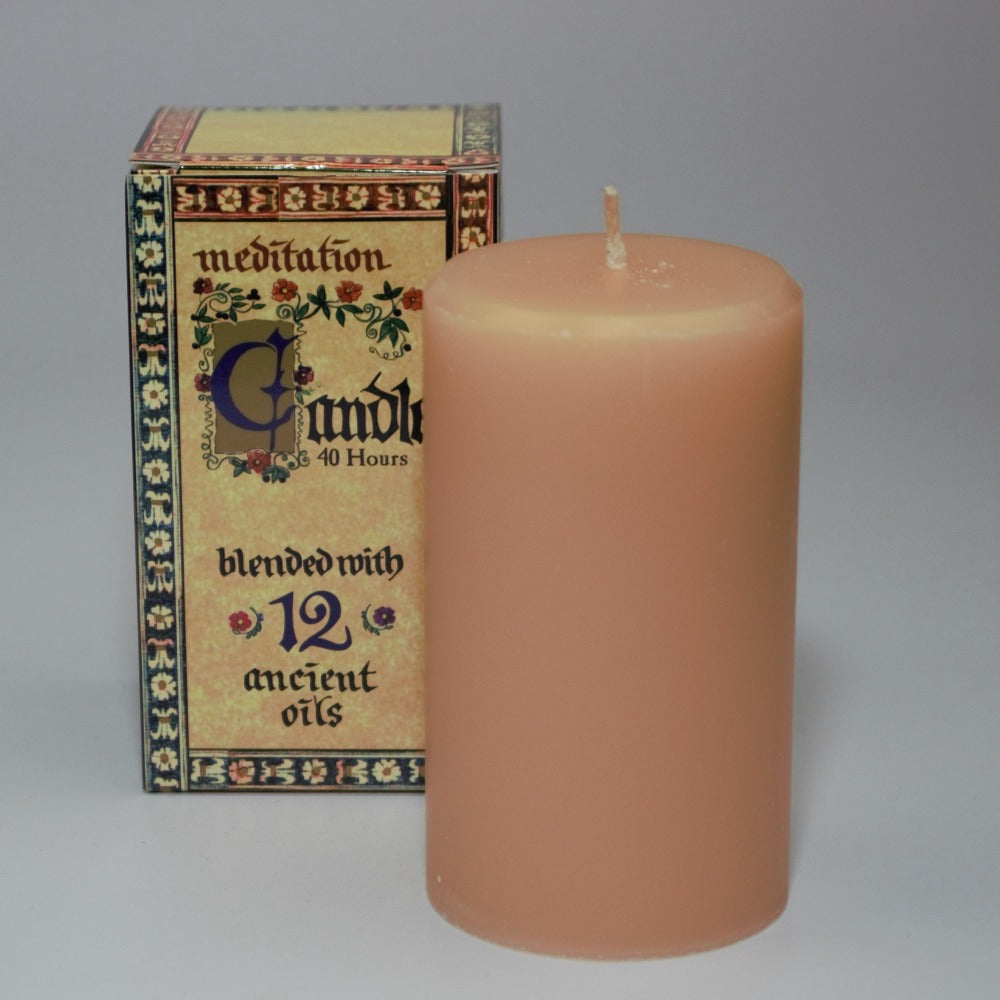 meditation candle 40 hour burn time, sitting in front of its packaging box, on a white background