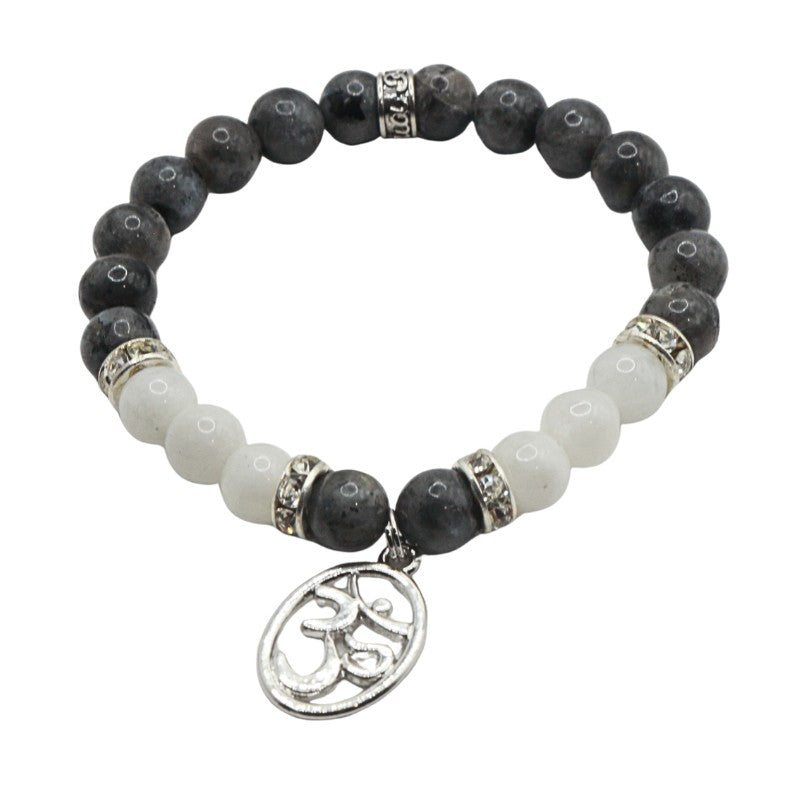 Bracelet with black and white beads and a silver charm on a white background