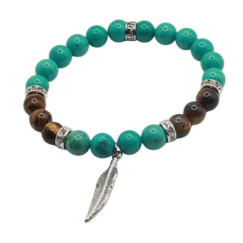 Turquoise beaded bracelet with brown accents and a silver leaf charm on a white background