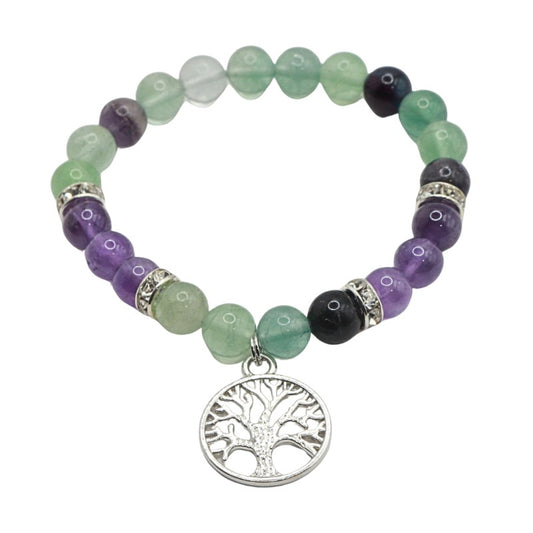 Beaded bracelet with tree of life charm on a white background