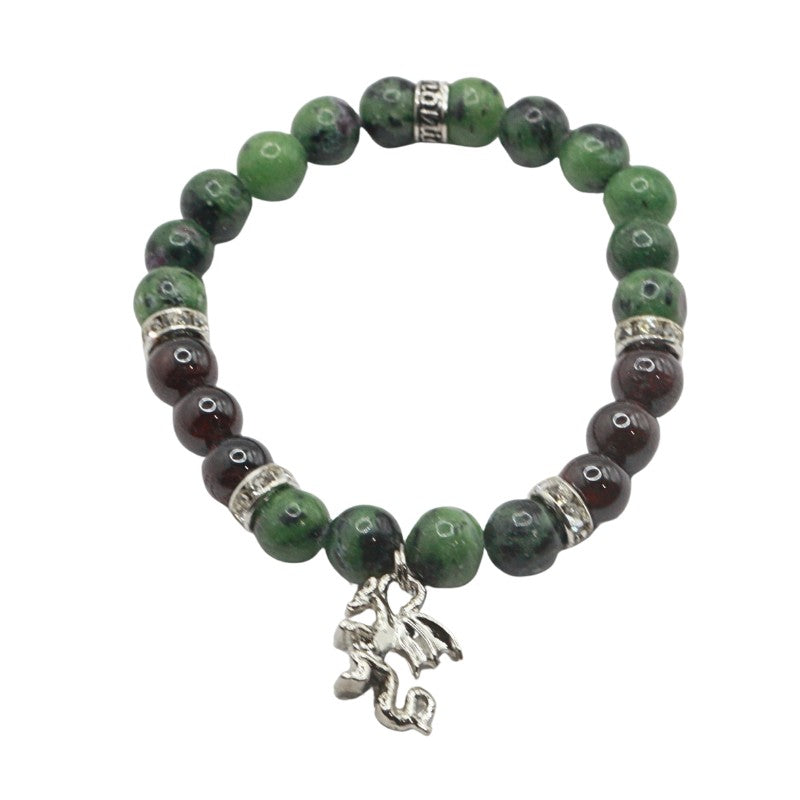 Green beaded bracelet with a silver charm on a white background