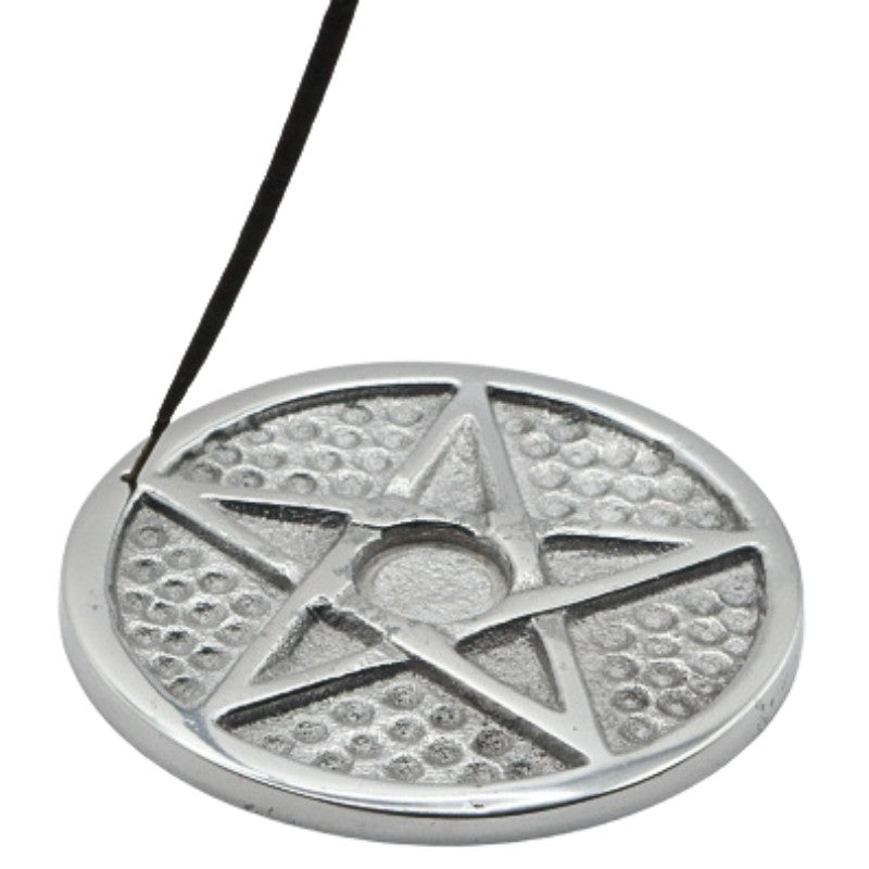 stick of incense in an aluminium pentacle incense holder