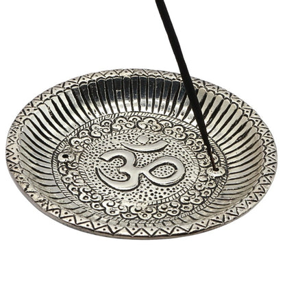 aluminium incense burner with om symbol holding a stick of incense