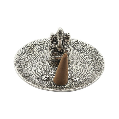 incense cone on an  aluminium incense burner with ganesh in the centre