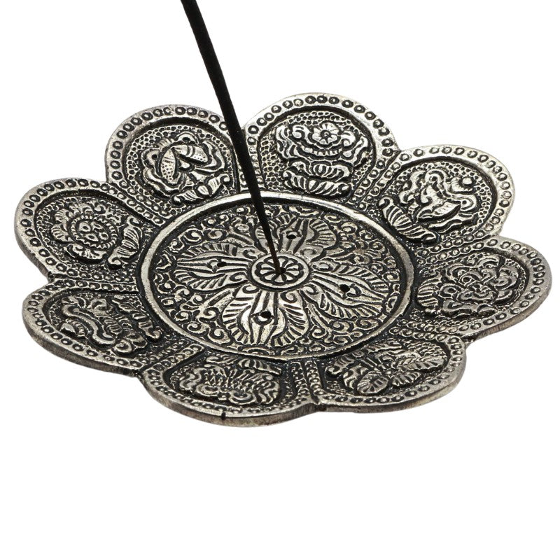 stick of incense in an  aluminium incense burner 