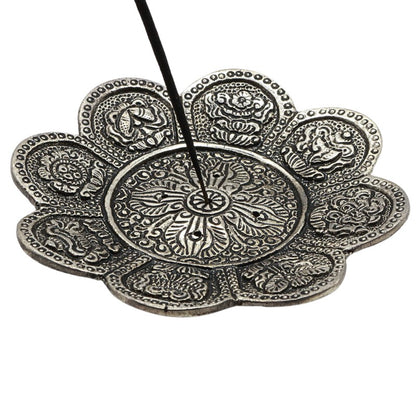 stick of incense in an  aluminium incense burner 