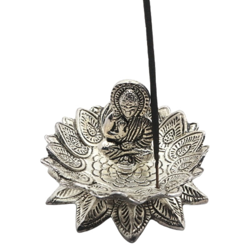 incense stick on a lotus shaped   aluminium incense burner with a buddha in the centre
