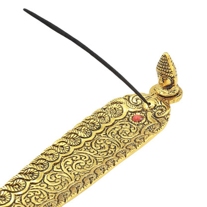 incense stick in a Gold aluminium incense holder with buddha head
