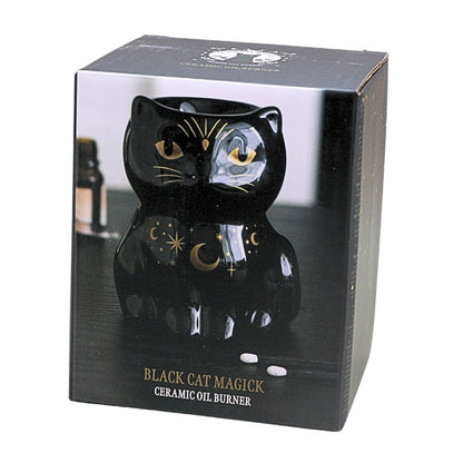 packaging box of a black cat shaped oil burner with gold stars and moons, on a white background