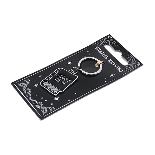 black and silver keyring that says spell book" in the shape of a book