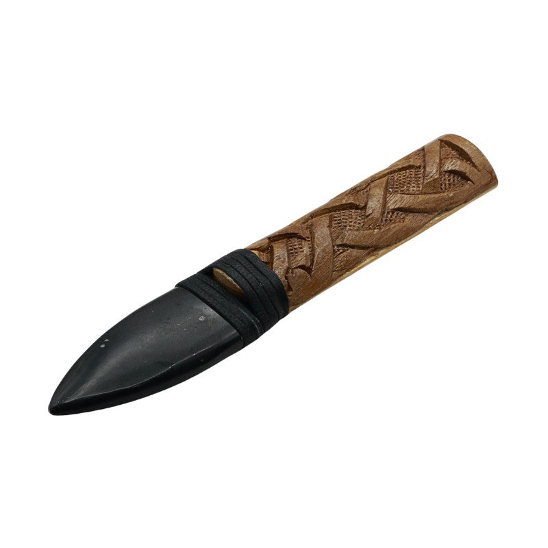 Decorative knife with a wooden handle and black blade on a white background
