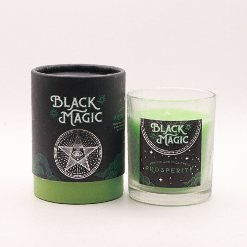 gift box next to a green prosperity candle in a glass jar 