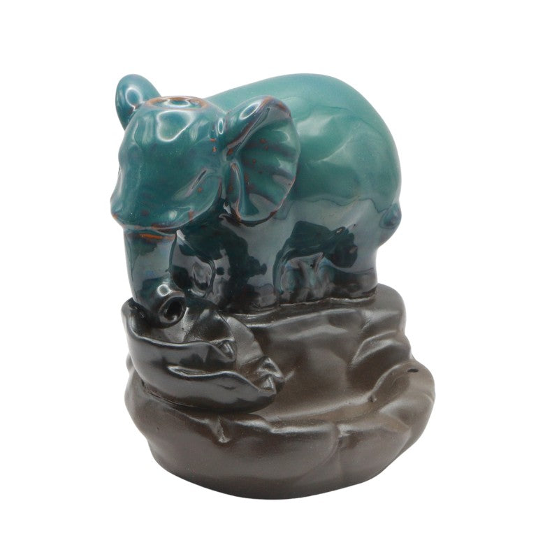 Ceramic elephant figurine with a brown base on a white background