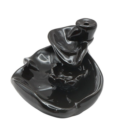 Black ceramic incense burner on a white background