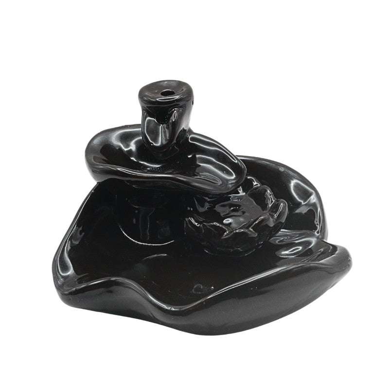 Black ceramic incense burner on a white background