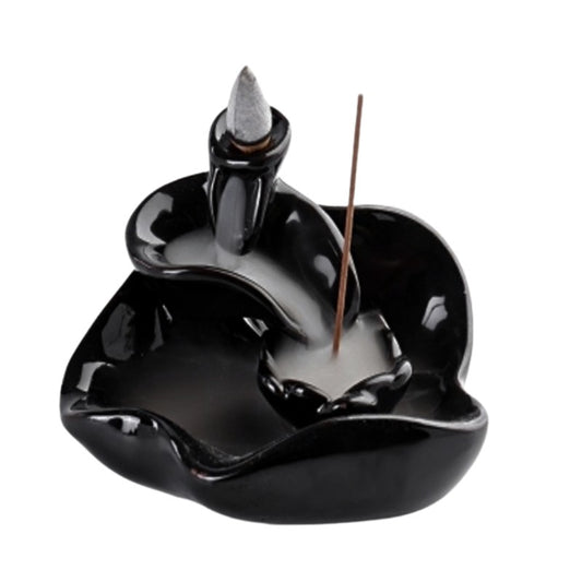 Black ceramic incense burner with a single incense stick on a white background