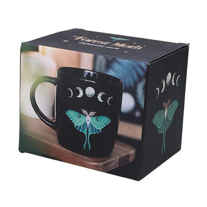 packaging box featuring a Black mug with Luna moth and moon phase design on white background