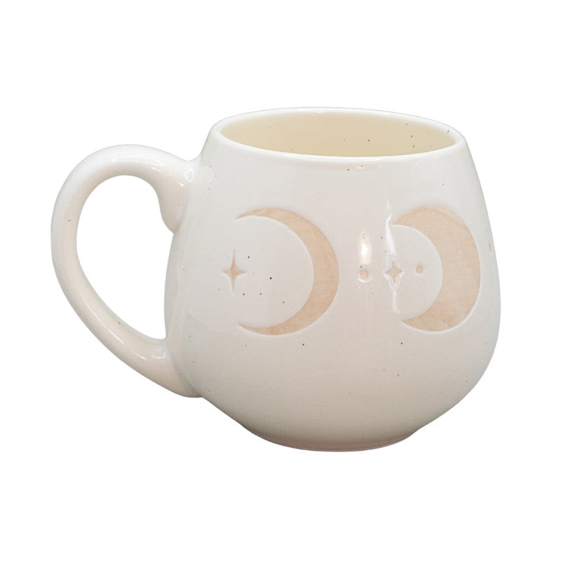 cream mug with crescent moon images on a white background
