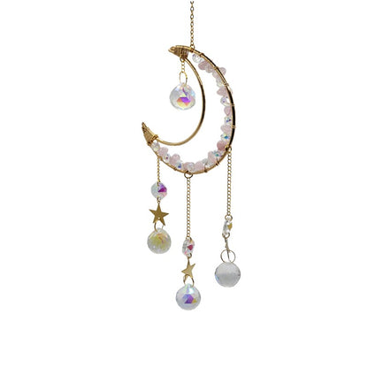 Decorative hanging ornament with moon shape, beads, and stars on a white background
