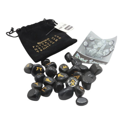 Black velvet bag with gold runic alphabet on front next to a set of black obsidian runes and a rune guide booklet