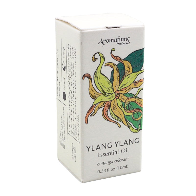 A box of Aromafume Naturals Ylang Ylang Essential Oil, featuring a white packaging design with a colorful illustration of a ylang flower and product details.