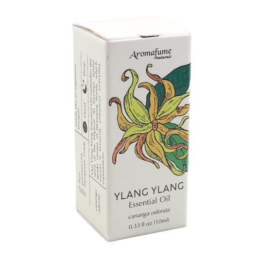 A box of Aromafume Naturals Ylang Ylang Essential Oil, featuring a white packaging design with a colorful illustration of a ylang flower and product details.