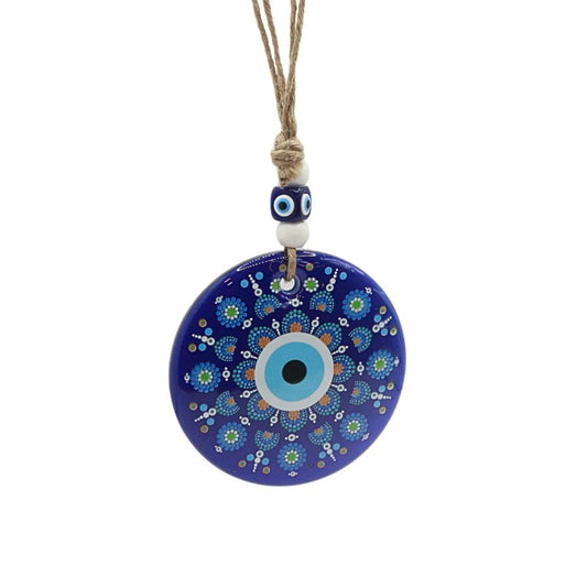 Decorative evil eye pendant with blue and white design on a white background