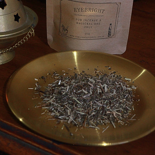 Eyebright incense on a gold plate with packaging in the background