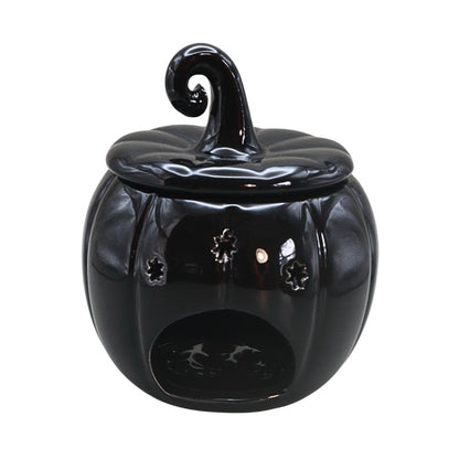 black pumpkin oil burner on white background