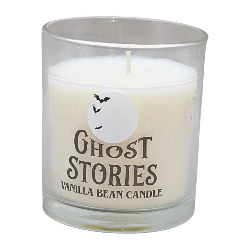 clear glass jar with white candle and label that says "ghost stories vanilla bean candle"