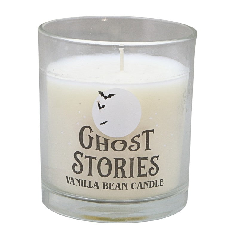 clear glass jar with white candle and label that says "ghost stories vanilla bean candle"