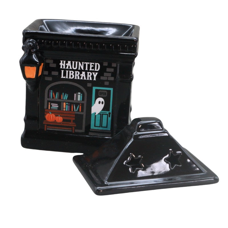 ceramic oil burner in the shape of a building with ghost and book images on, titled "haunted library"