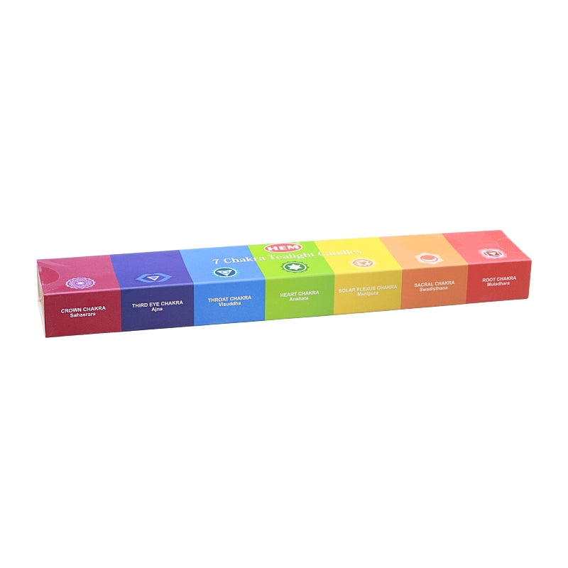 A long rectangular box of HEM 7 Chakra Tealight Candles, showing a colourful side panel with six distinct coloured segments representing the chakras, set against a plain white background.