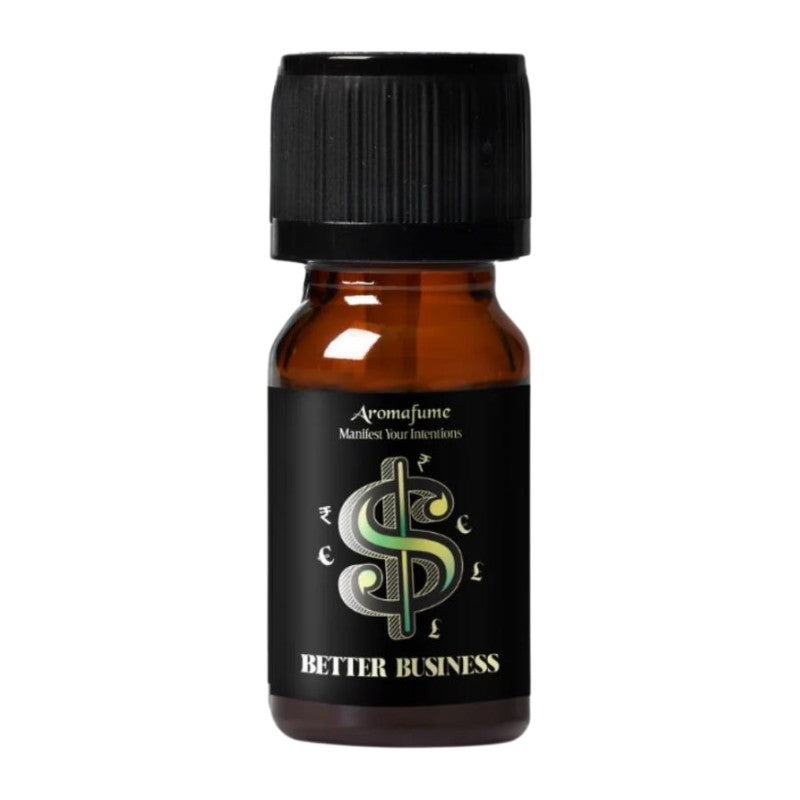 A small amber glass bottle with a black ribbed cap and a black label reading 'Aromafume' and 'Better Business' with a stylized green and silver dollar sign, on a plain white background.