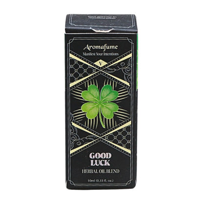 A rectangular black box of Aromafume Good Luck Herbal Oil Blend, featuring a green four-leaf clover design and gold decorative borders on a white background.