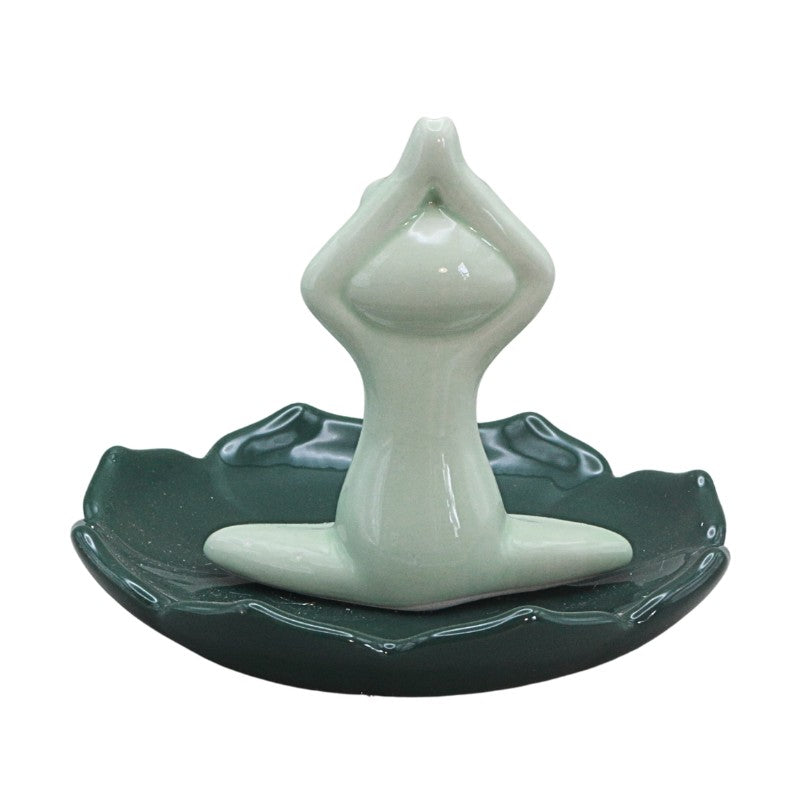 green frog sitting cross legged on lil pad holding hands above head