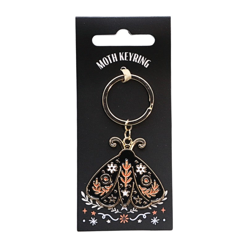 black and orange keyring in the shape of a moth with a gold chain on a black hang tag 