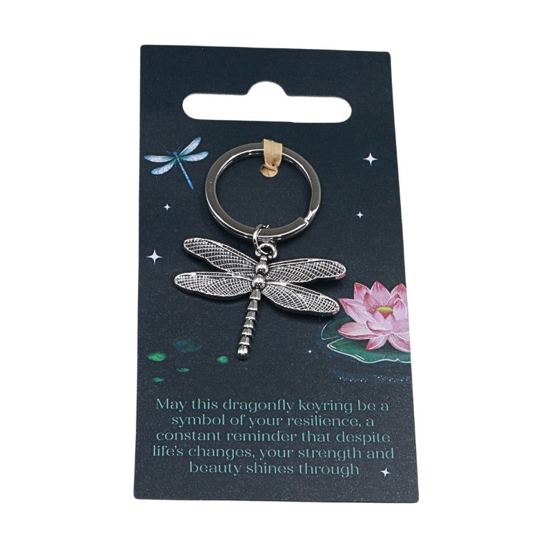 Dragonfly keychain on a decorative card with floral illustrations