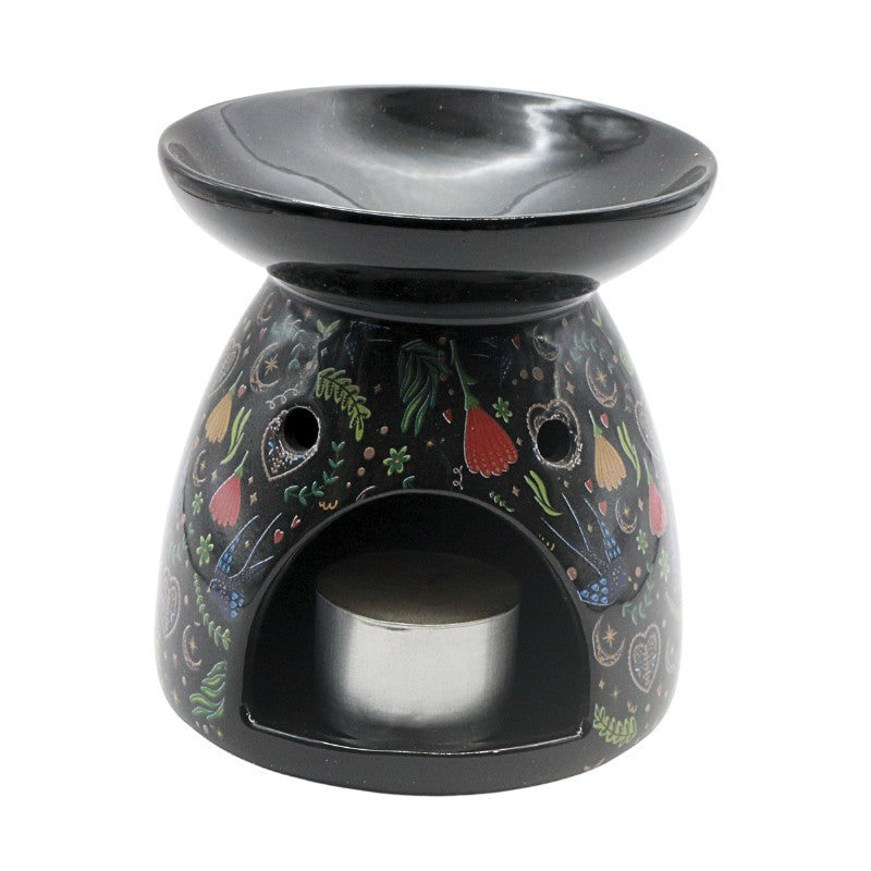 Decorative oil burner with floral patterns on a white background